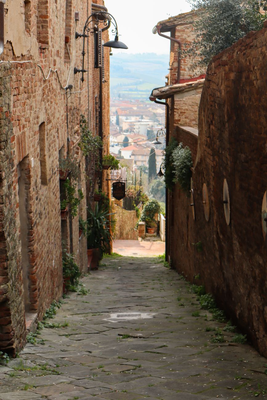 Tuscan stone farmhouse along cypress roads